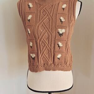 Tan crochet sweater vest with daisy
Medium